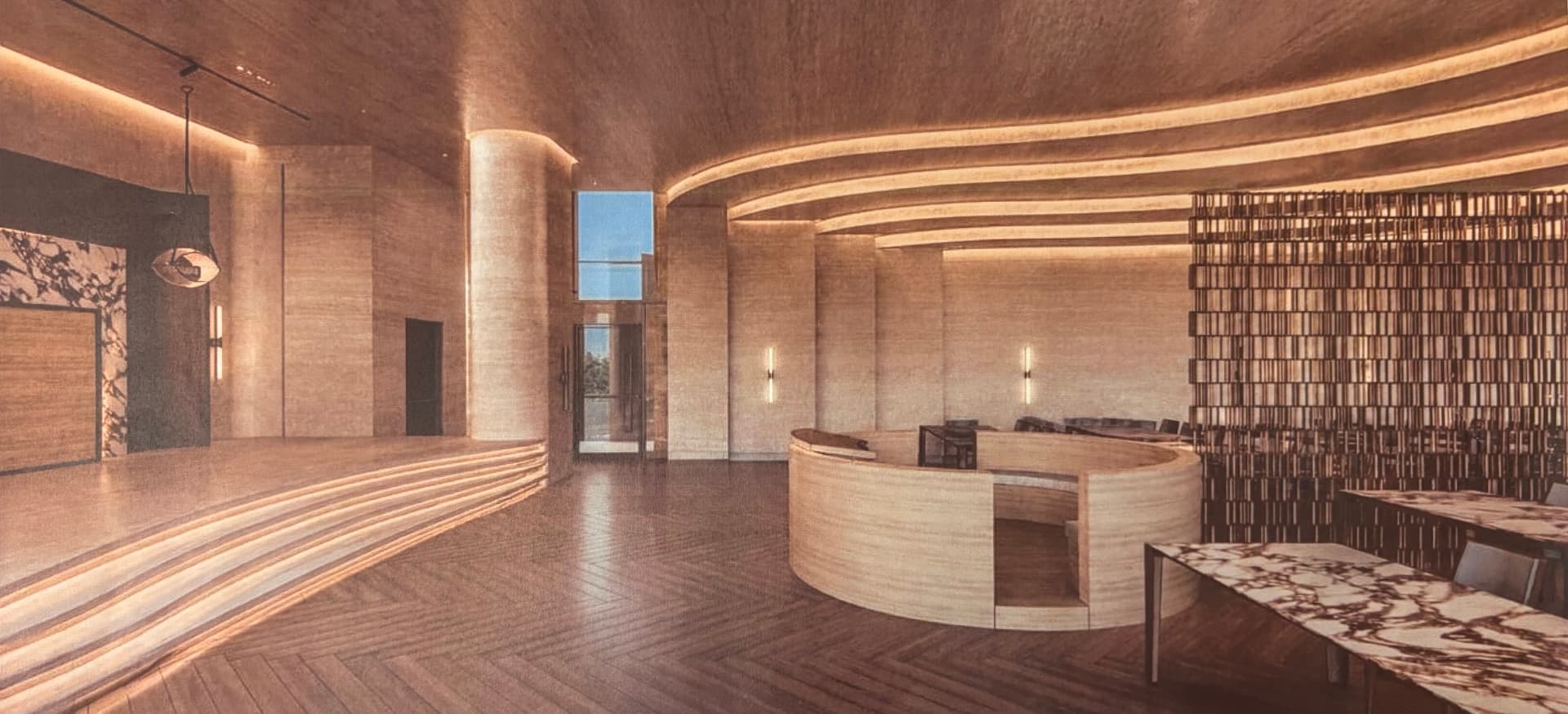 Wide view of the entrance foyer with travertine columns, curved lighting coves and herringbone floors